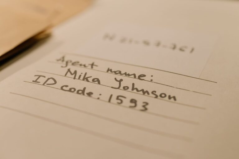 Handwritten document with agent name and ID code, showcasing personal handwritten text.